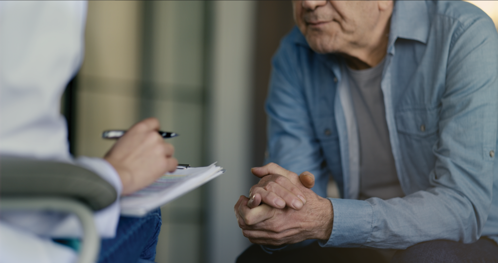 man talking to his doctor about his symptoms of prostate cancer